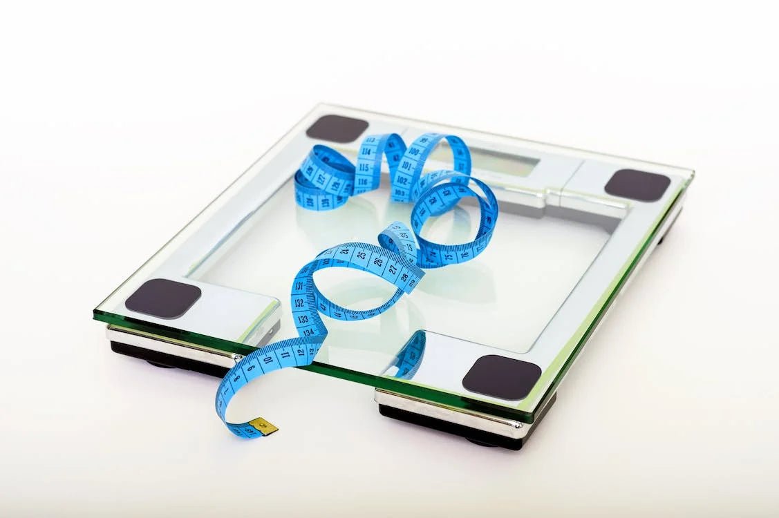Weight scale with blue measuring tape